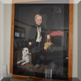 A35. Framed print of Victorian boy with small white dog. Frame: 32.5”h x 25.5”w